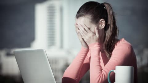Person-at-Computer-With-Head-in-Hands-Wondering-if-They-Need-a-Houston-Rape-Lawyer