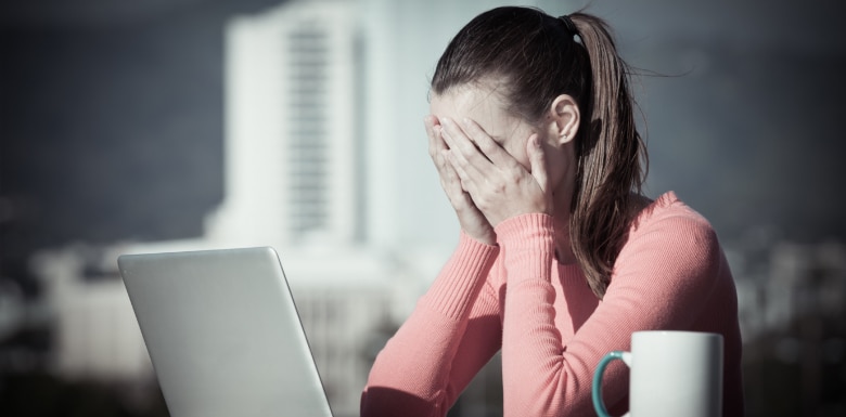 Person-at-Computer-With-Head-in-Hands-Wondering-if-They-Need-a-Houston-Rape-Lawyer