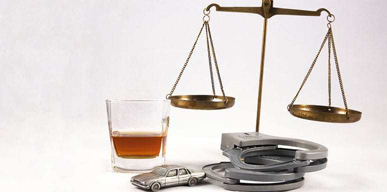 Scale-Surrounded-by-Handcuffs-and-Booze