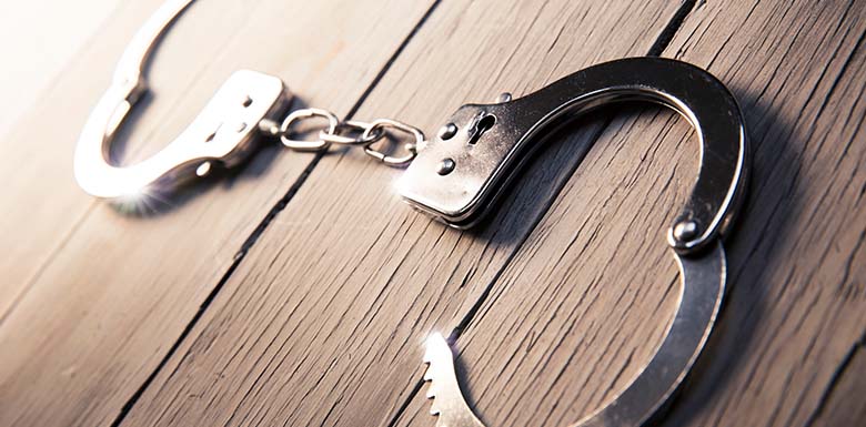 Open handcuffs on wood table