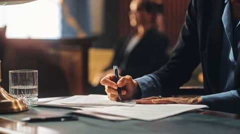 Lawyer using pen to write document