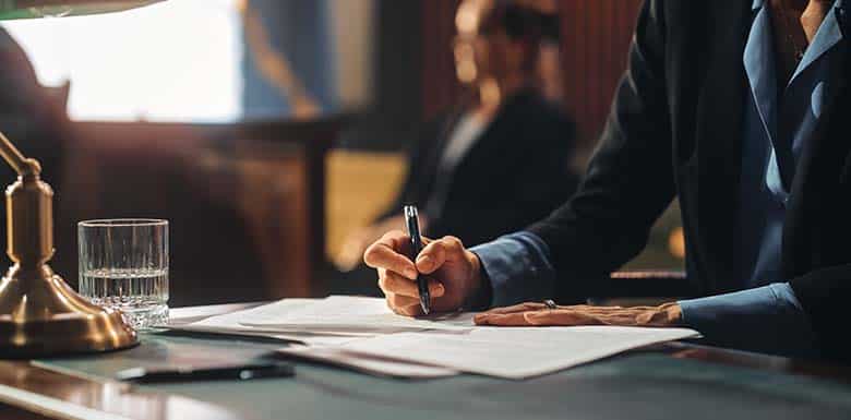 Lawyer using pen to write document