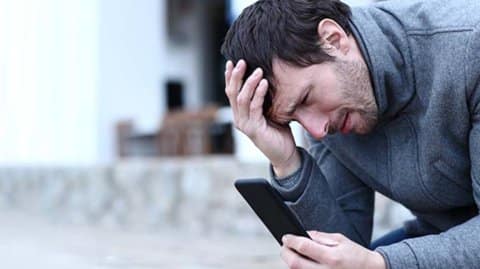 Man angry looking at phone
