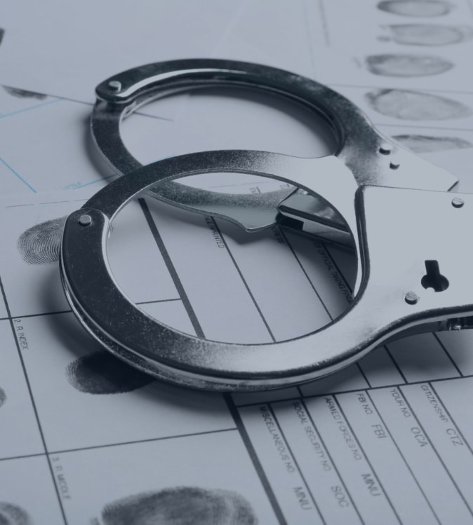 pair of handcuffs laying on police documents
